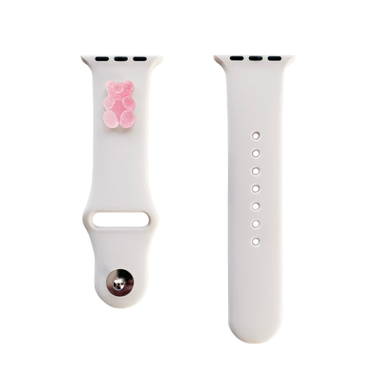 A small pink 3D printed gummy bear attached to a starlight silicon watch band for the apple watch