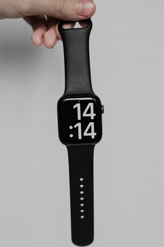 A man holding a black strap on an apple watch series 8