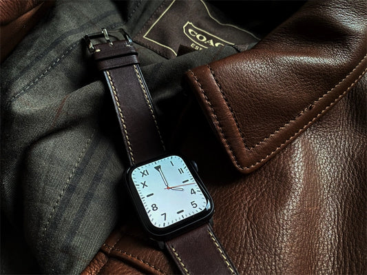 leather apple watch band on a black series 8 41mm apple watch on top of a leather jacket