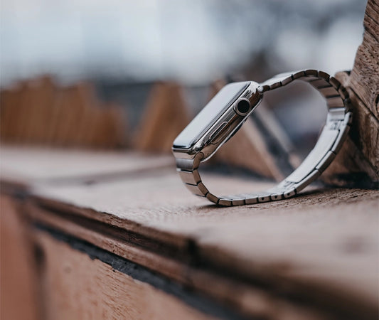 stainless steel metal apple watch series 9 45mm on a wooden ledge