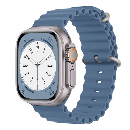 A dull blue colour silicon watch strap with two buckles on an apple watch series 9 and ultra 2 designed for the ocean which is also called an ocean band