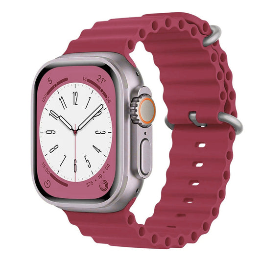 An Burgundy red colour silicon watch strap with two buckles on an apple watch series 9 and ultra 2 designed for the ocean which is also called an ocean band