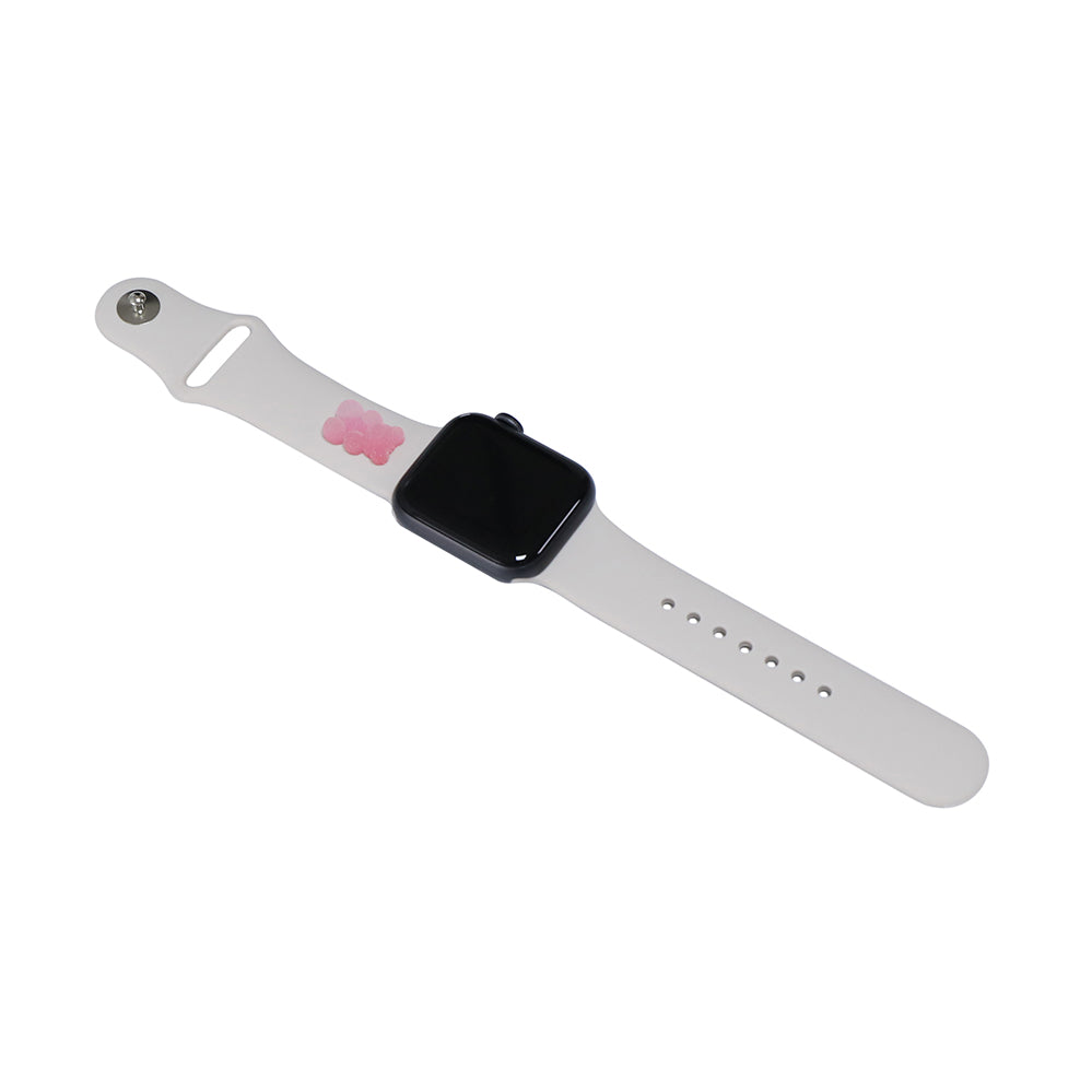 A small pink 3D printed gummy bear attached to a starlight silicon watch band for the apple watch