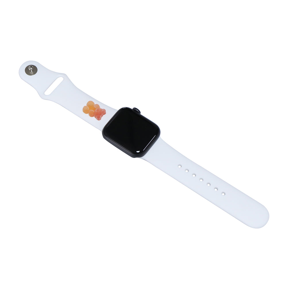 A small red and orange 3D printed gummy bear attached to a white silicon watch strap for the apple watch