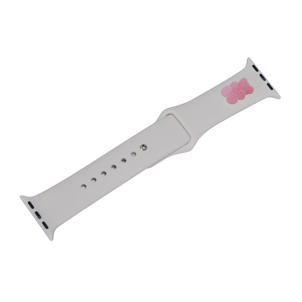 A small pink 3D printed gummy bear attached to a starlight silicon watch strap for the apple watch